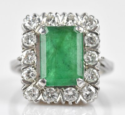 Lot 395 - An 18ct white gold diamond and emerald cluster...