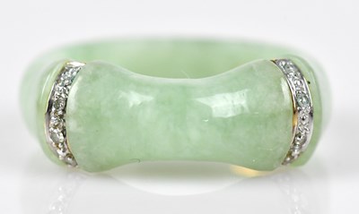 Lot 588 - A Chinese green hardstone dress ring set with...