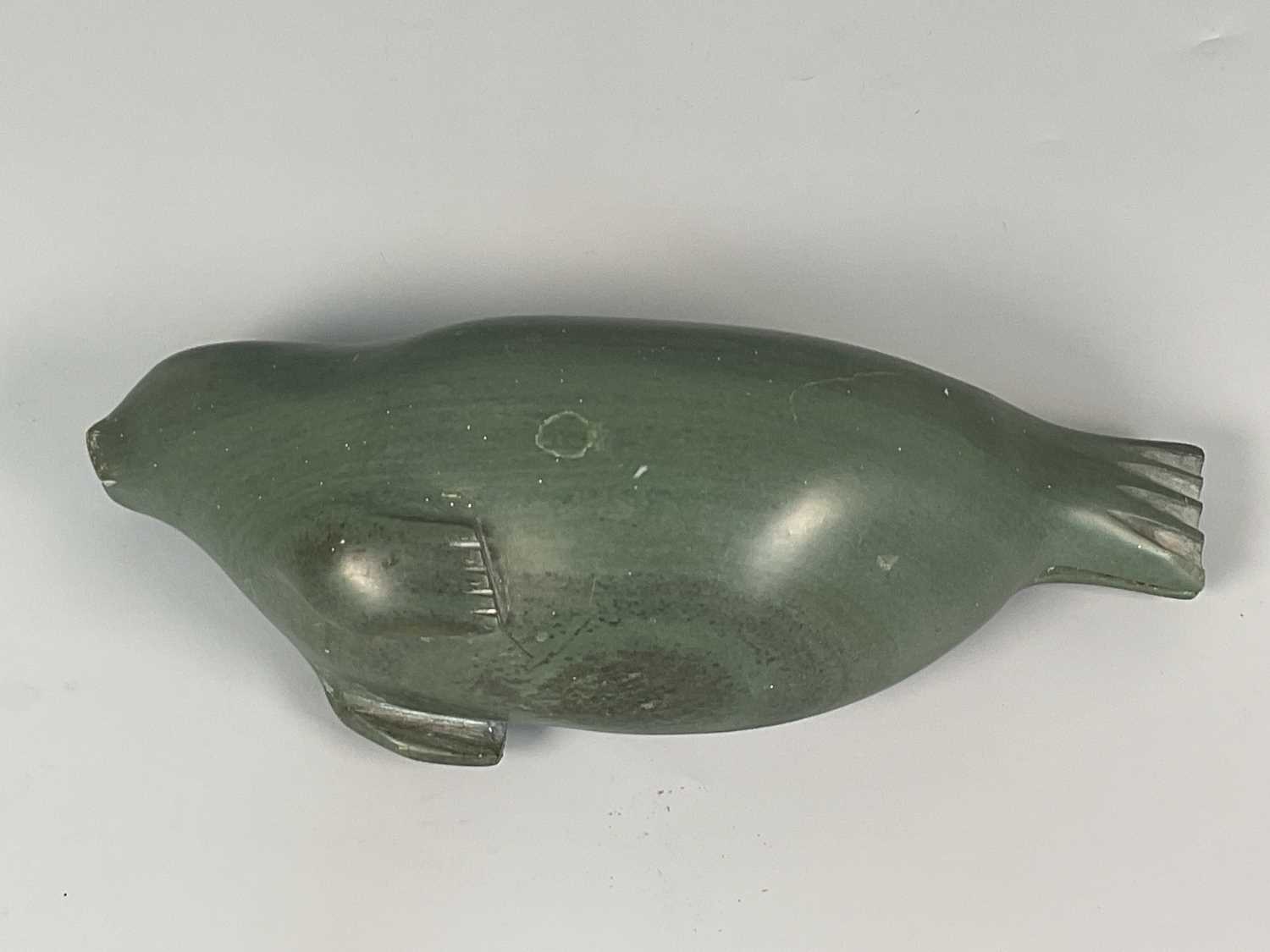 Lot 1 - An Inuit dark green soapstone carving of a...