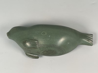 Lot 1 - An Inuit dark green soapstone carving of a...