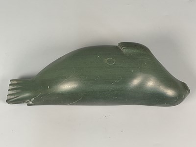 Lot 1 - An Inuit dark green soapstone carving of a...