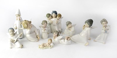 Lot 677 - A group of ten figures, to include angelic...