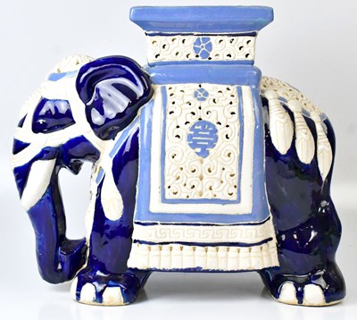 Lot 49 - A blue and white ceramic footstool in the form...
