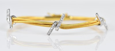 Lot 107 - An 18ct yellow and white gold textured...