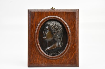 Lot 611 - A 19th century bronze panel, side profile Nero...