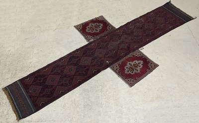 Lot 1411 - A large Afghan runner with stylised lozenge...