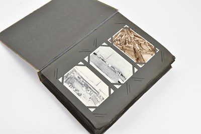 Lot 1444 - An early 20th century postcard album...