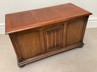 Lot 1244 - A reproduction oak blanket chest on bun feet.