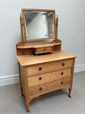 Lot 1245 - An early 20th century oak three drawer...