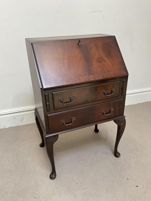 Lot 1302 - A reproduction mahogany two drawer bureau on...
