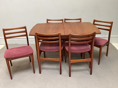 Lot 1020 - A mid century teak dining suite comprising...