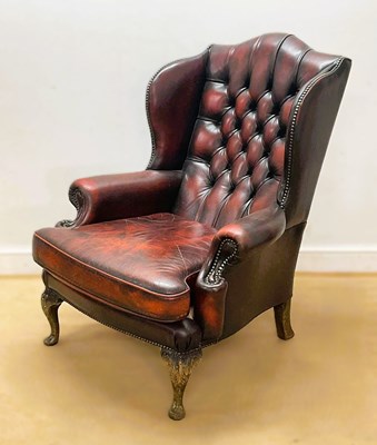 Lot 689 - A red leather buttonback Chesterfield wingback...