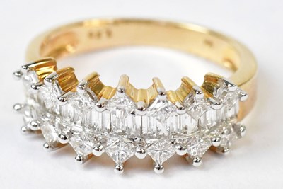 Lot 593 - A 9ct yellow gold ring set with a row of...