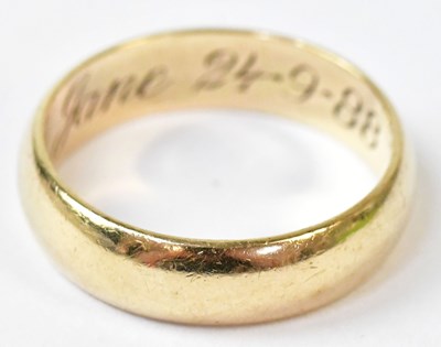 Lot 589 - A 9ct yellow gold wedding band, with...
