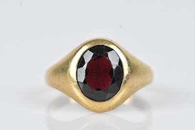 Lot 451 - A 9ct yellow gold garnet set signet ring, the...