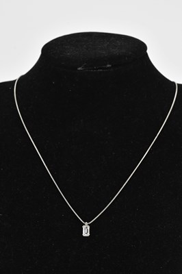 Lot 219 - An emerald cut diamond pendant on chain in...
