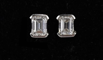 Lot 166 - A pair of emerald cut diamond ear studs in...