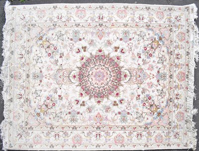 Lot 68 - An Iranian silk Tabriz rug, with central...