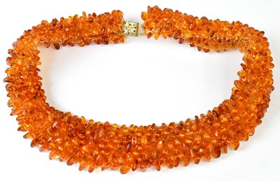Lot 601 - A beaded amber collar necklace set with amber...