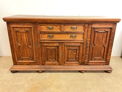 Lot 813 - An early 20th century oak sideboard with three...