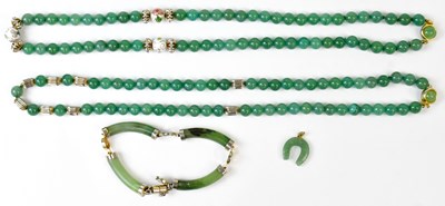 Lot 583 - Four items of green jade jewellery, comprising...