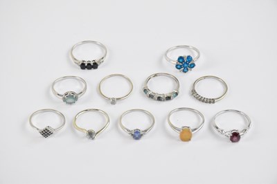 Lot 875 - Nine 10ct white gold rings set with gemstones,...