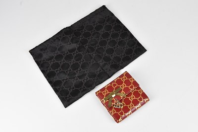 Lot 1267 - GUCCI; a red patent leather wallet, with GG...