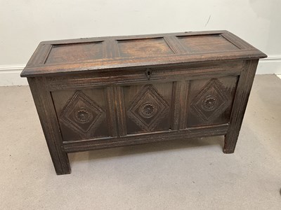Lot 1059 - An 18th century oak coffer, with carved...