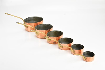 Lot 2121 - A graduated set of six copper and brass...