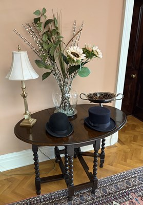 Lot 1246 - An oak gateleg table, with two two top hats,...