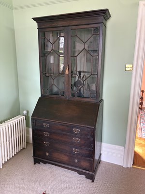 Lot 1073 - An Edwardian oak bureau bookcase, with...