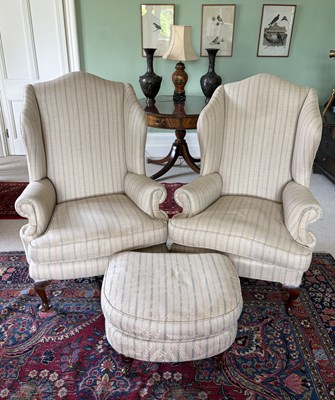 Lot 1175 - A pair of George II style wing back salon...