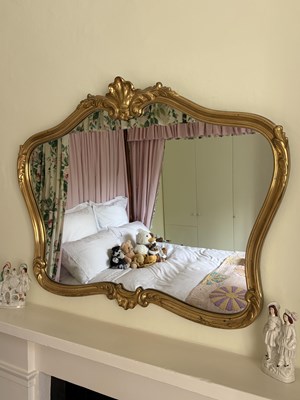 Lot 1014 - A modern cartouche shaped gilt frame mirror,...