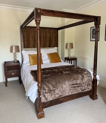 Lot 1162 - A modern stained pine four poster bed, with...