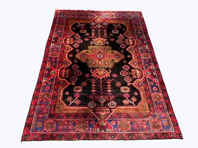 Lot 1395 - A Caucasian wool rug, worked with a geometric...