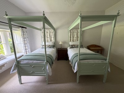 Lot 1170 - A pair of green painted four poster single...