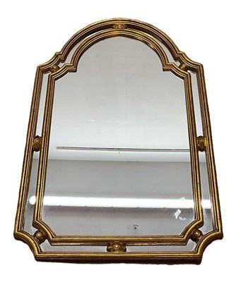 Lot 676 - An ornate gilt framed mirror with arched top,...