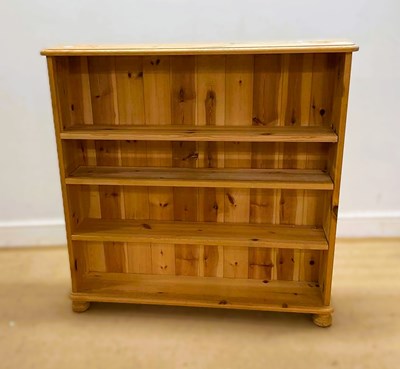 Lot 706 - A modern pine bookshelf with three adjustable...
