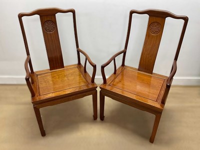 Lot 691 - A pair of contemporary Chinese hardwood chairs,...