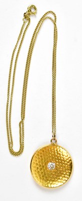 Lot 606 - A 22ct yellow gold circular pendant set with a...