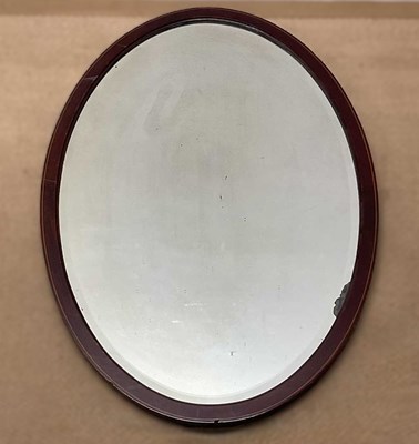 Lot 747 - A large mahogany bevelled edge oval mirror,...