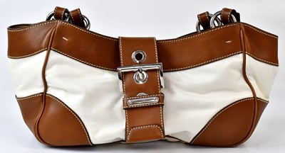 Lot 406 - PRADA; a beige with brown trim handbag, with...