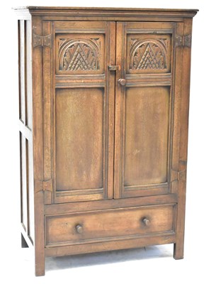 Lot 51 - A Priory-style oak hall cupboard, with pair of...