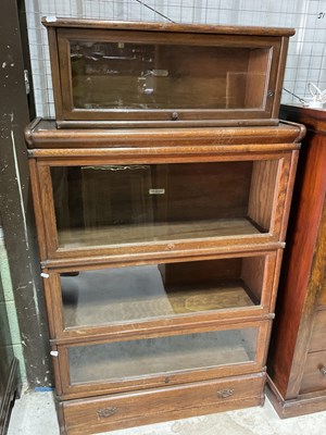 Lot 648 - GLOBE WERNICKE; an oak three section bookcase,...