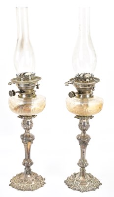 Lot 2227 - A pair of electroplated oil lamps, height...