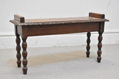Lot 1221 - An early 20th century carved oak bench, height...