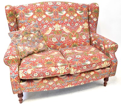 Lot 48 - A two-seater wingback settee, upholstered in...