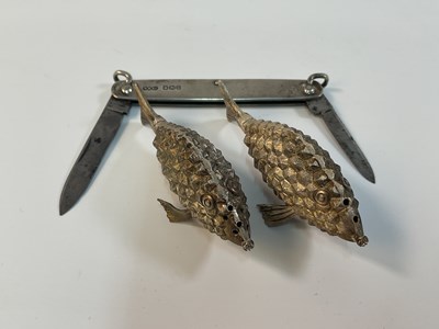 Lot 558 - A sterling silver two piece cruet in the form...