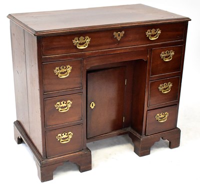 Lot 82 - A Georgian mahogany kneehole desk comprising...
