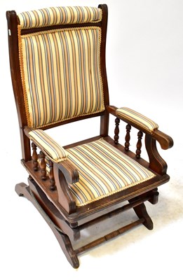 Lot 37 - An American beech rocking chair, with spindle...